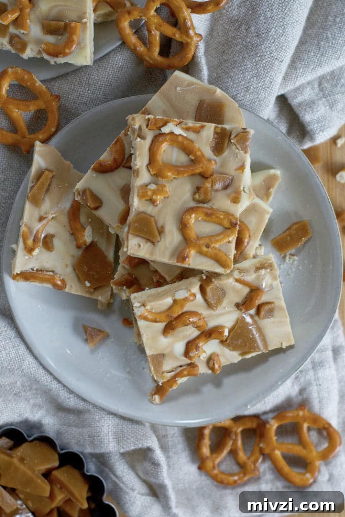 Cookie Butter White Chocolate Bark Recipe | Crunchy Cookie Butter Bark 11 cookie butter white chocolate bark piled on a plate