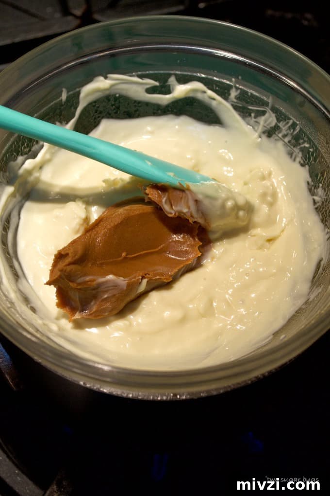 Cookie Butter White Chocolate Bark Recipe | Crunchy Cookie Butter Bark 7 white chocolate and cookie butter in a double boiler on the stove