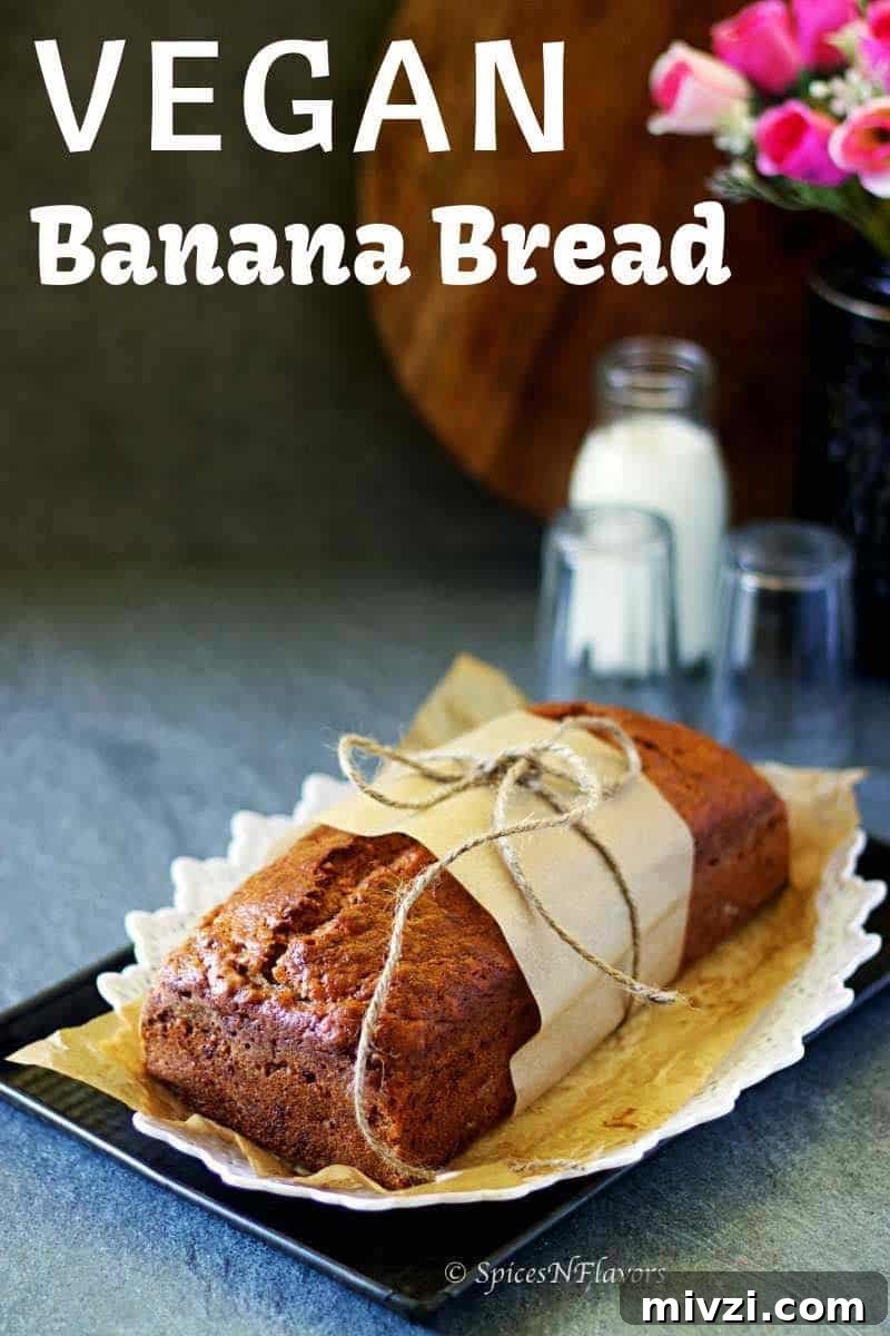 Moist Vegan Banana Bread Recipe with Simple Ingredients 2 banana bread wrapped in a parchment paper and placed on a white tray