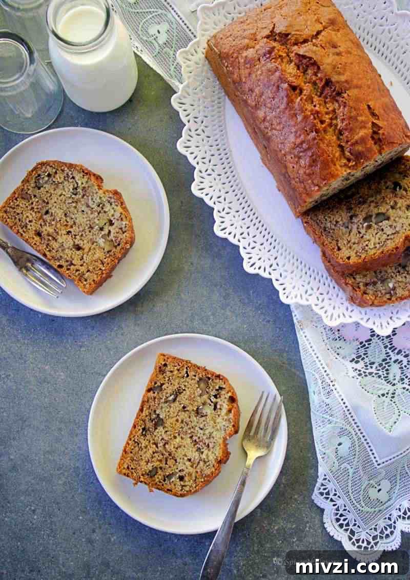 Moist Vegan Banana Bread Recipe with Simple Ingredients 9 banana bread slices placed on a plate along with the whole bread on one side and milk on the other side