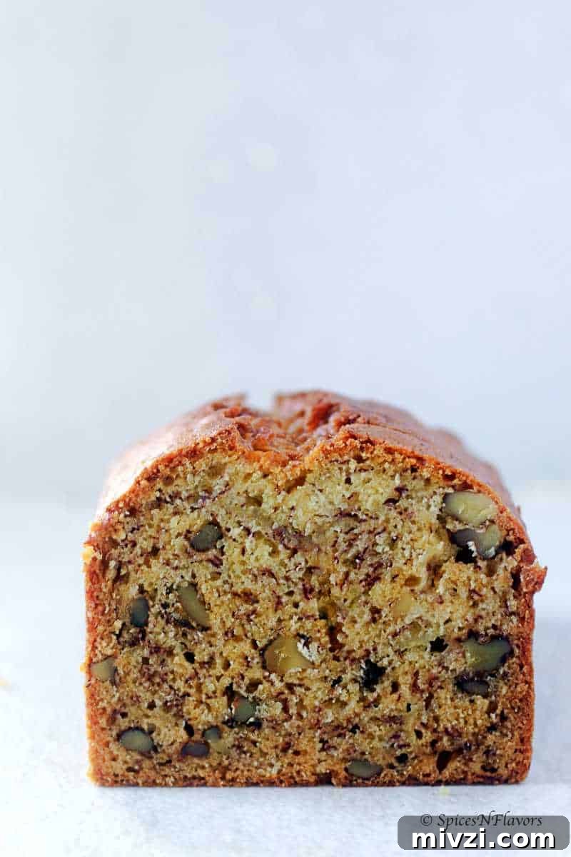 Moist Vegan Banana Bread Recipe with Simple Ingredients 10 cur banana bread showing the texture from within and the dispersion of walnuts