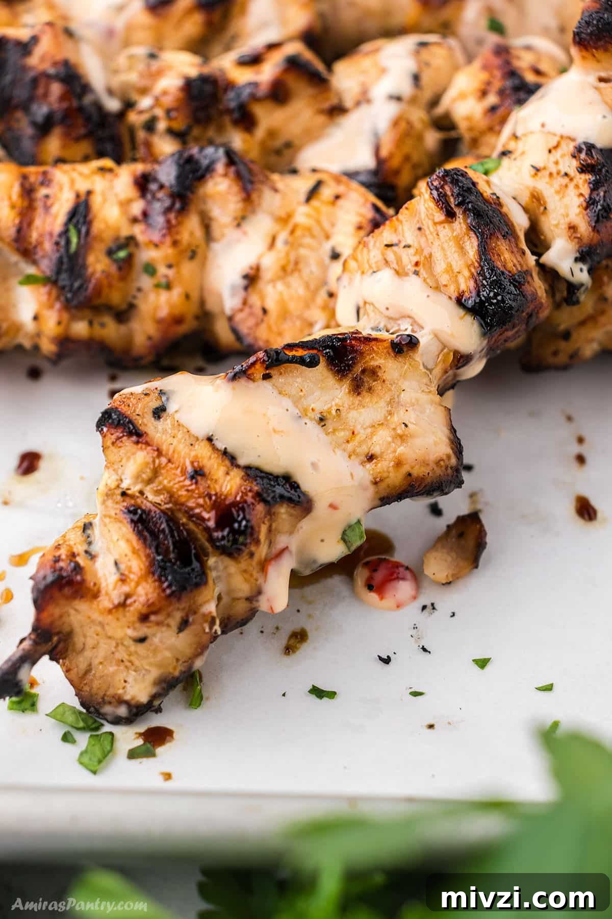 Spicy Bang Bang Chicken Skewers Recipe for Grilled Poultry 2 Bang bang chicken skewers on a serving plate.