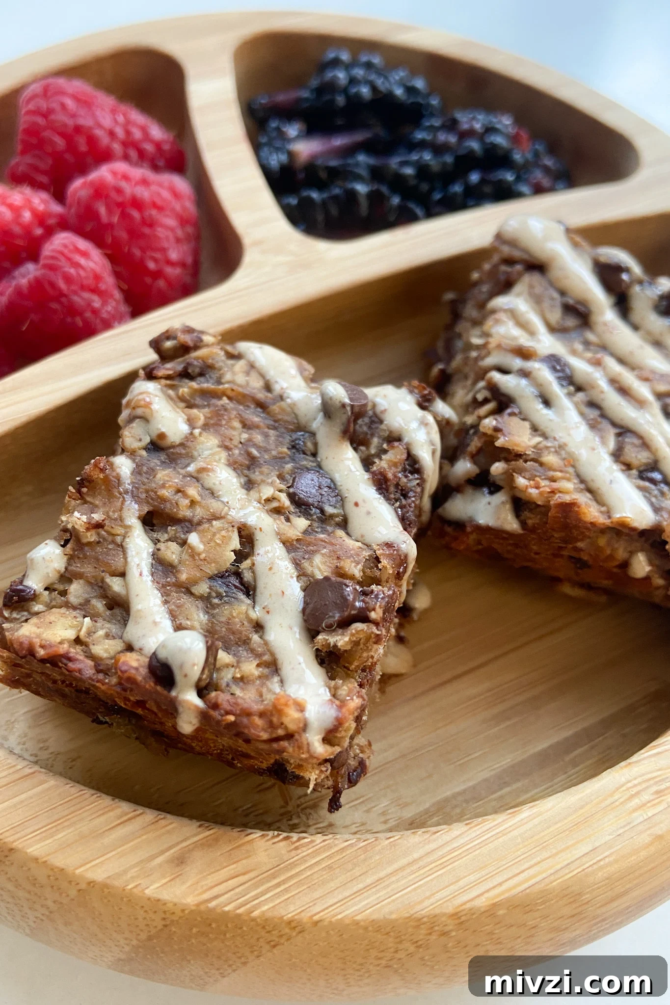 Banana Peanut Butter Protein Bars: No-Bake Snack Recipe 2 Peanut butter banana oat bars served with raspberries and blackberries
