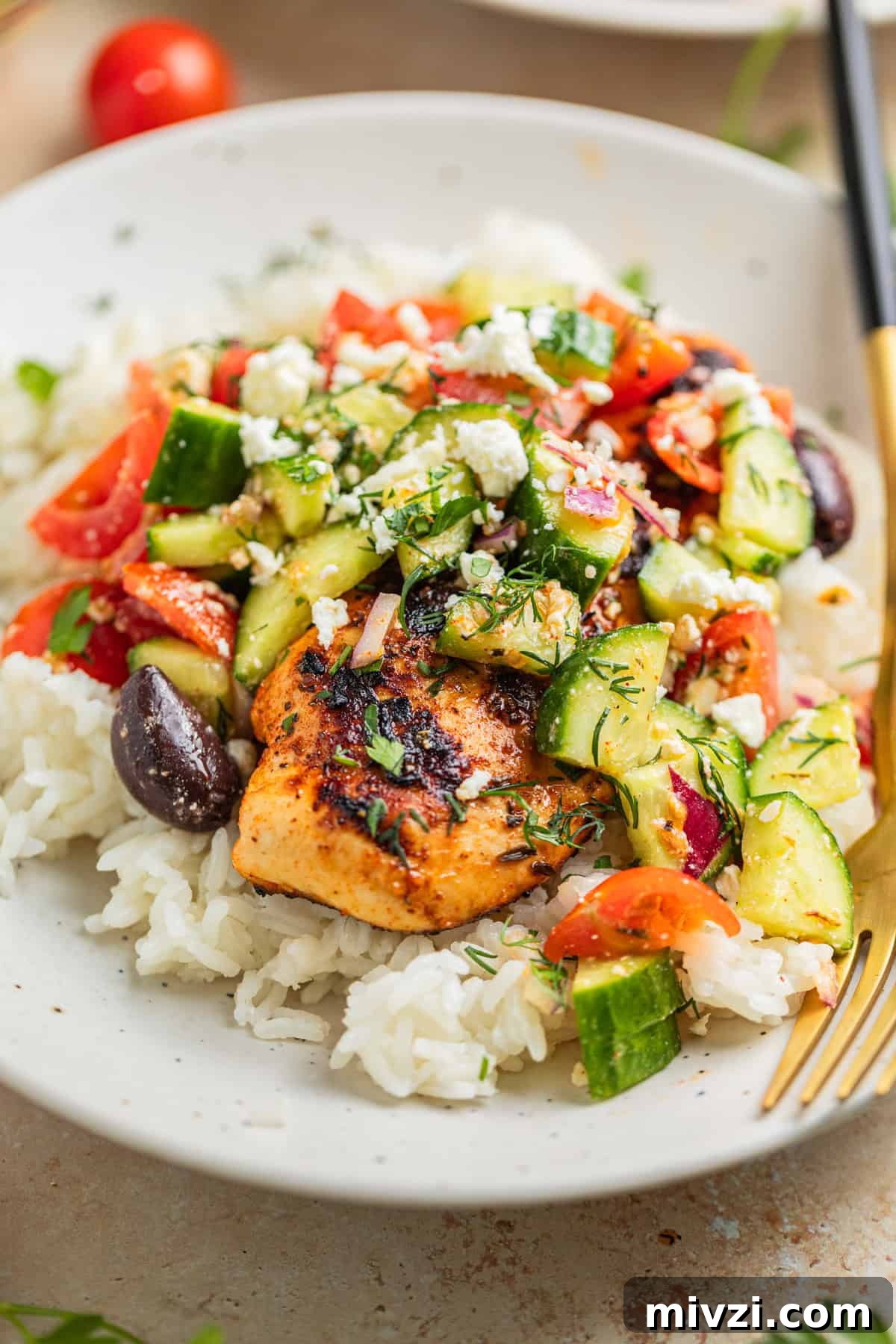 Mediterranean-Style Grilled Chicken with Lemon and Herbs 2 Grilled marinated mediterranean chicken on rice topped with greek cucumber salad.