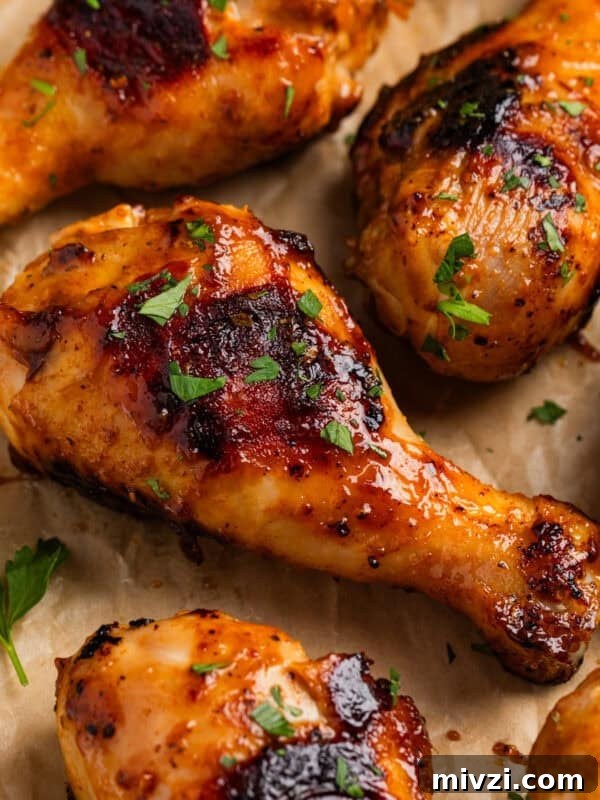 Mediterranean-Style Grilled Chicken with Lemon and Herbs 12 Honey mustard chicken drumsticks on parchment with chopped parsley.