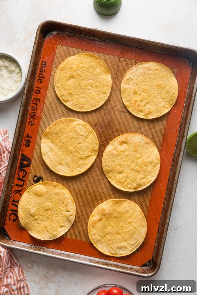 Pinto Bean Tostadas with Fresh Tomato and Corn Salsa 4 Six tostadas on a large rimmed baking sheet.