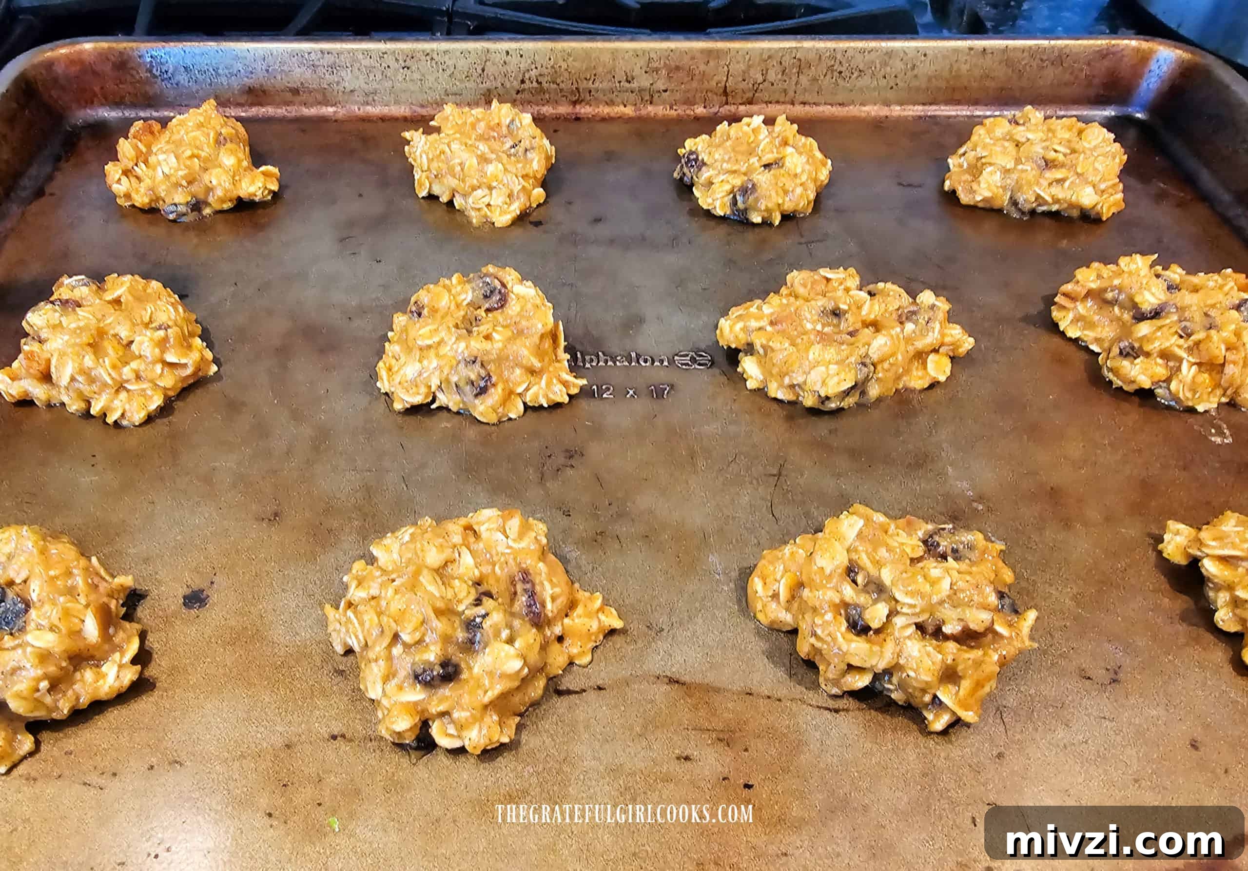 Cookie dough is dropped onto baking sheets, then dough is slightly flattened.