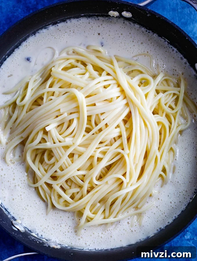 Creamy Chicken Alfredo Pasta Recipe: Quick Garlic Parmesan Dinner 4 alfredo pasta cooking in a skillet