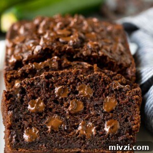Sliced chocolate zucchini bread filled with melted chocolate.