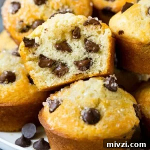 A cross section of a cut chocolate chip muffin.
