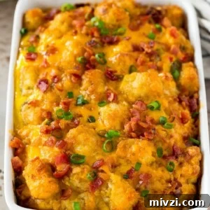 Tater tot breakfast casserole topped with bacon and green onions.
