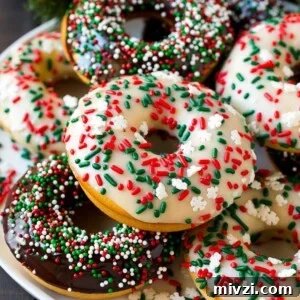 A serving plate of baked donuts frosted in dark and white chocolate and topped with sprinkles.