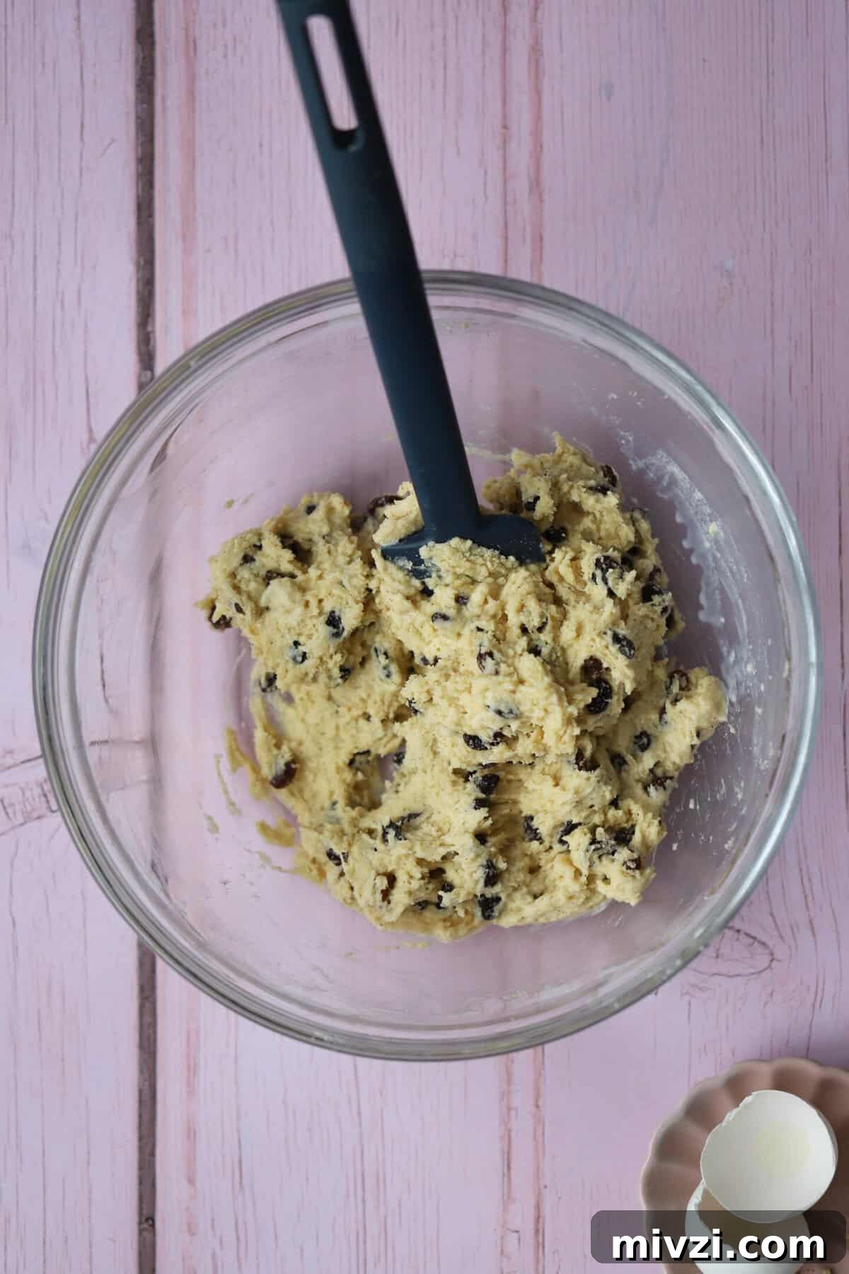 Add the milk, eggs and dried fruit to form a sticky dough.