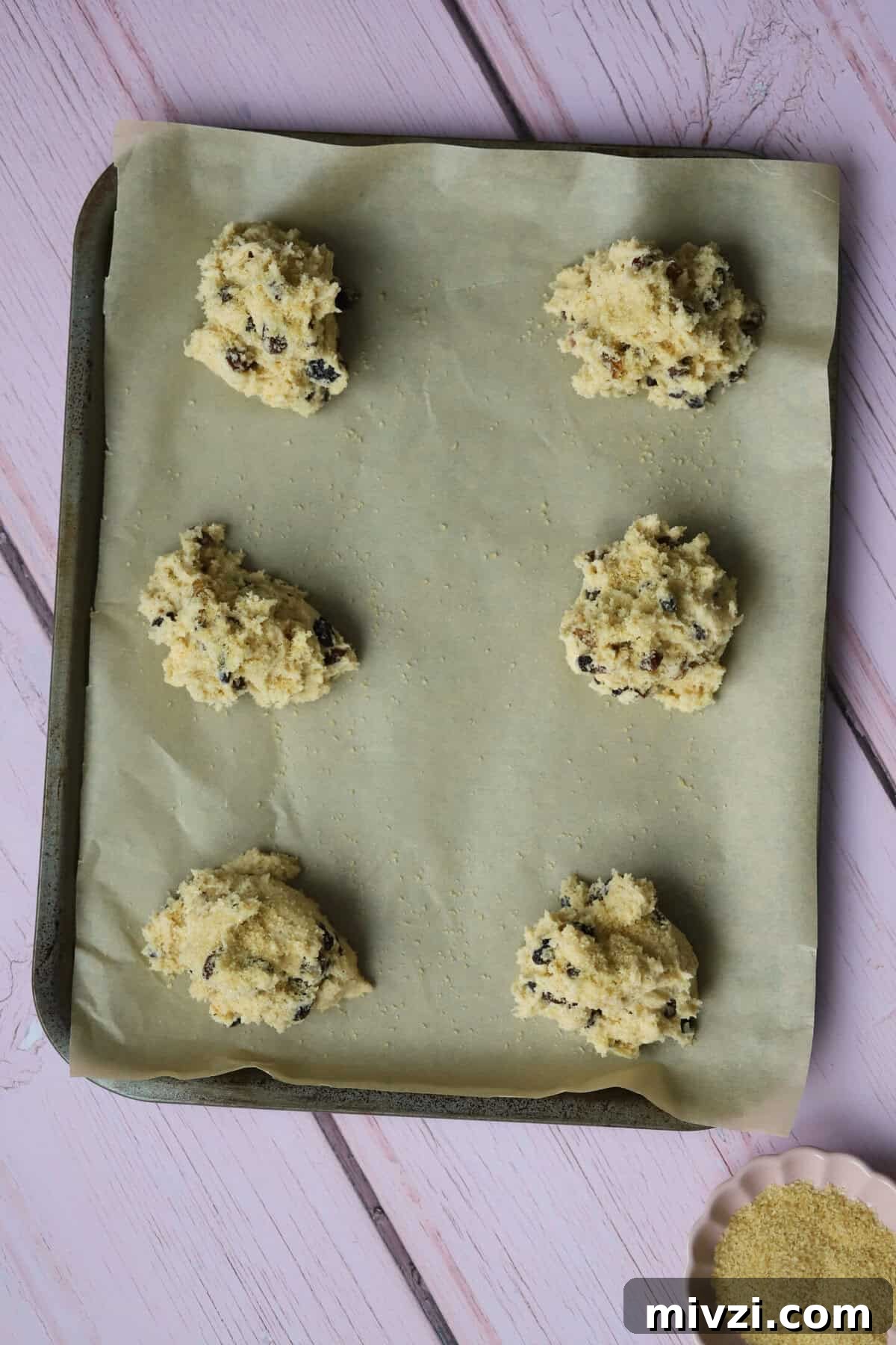 Spoon the mixture onto a lined baking tray, sprinkle with sugar and bake.