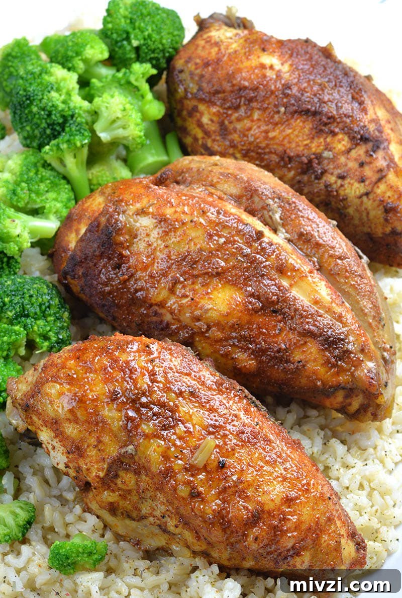 Cheesy Chicken Parmesan Casserole Bake Recipe 3 Three pieces of Healthy Slow Cooker Chicken Breasts on rice and broccoli.