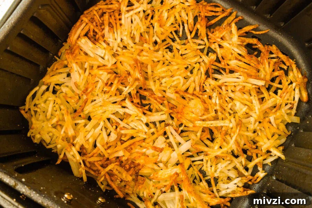 Crispy Air Fryer Hash Browns in 15 Minutes 5 Golden brown crispy hash browns in the air fryer basket