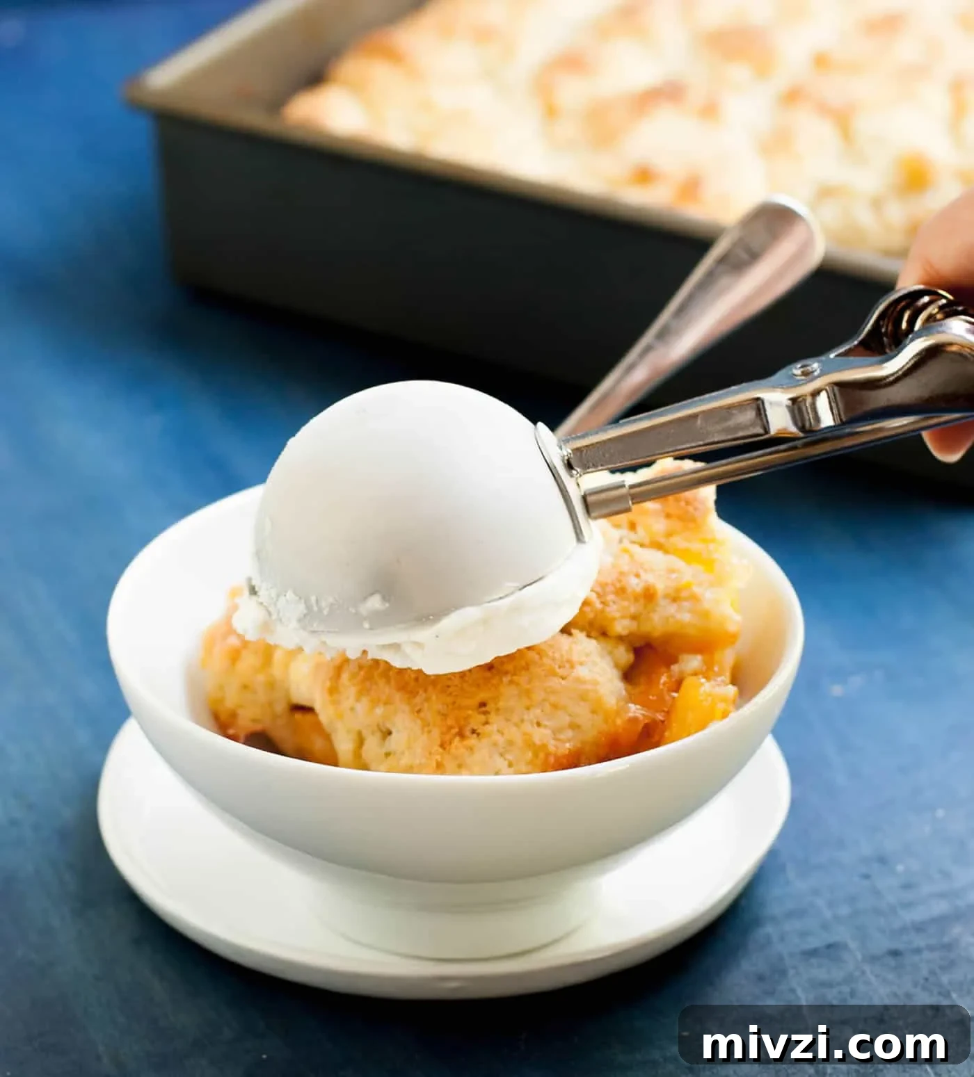 Georgia Peach Cobbler. Fresh peaches, lightly spiced and sweetened with two kinds of sugar, are baked under a delicious sweet biscuit topping!
