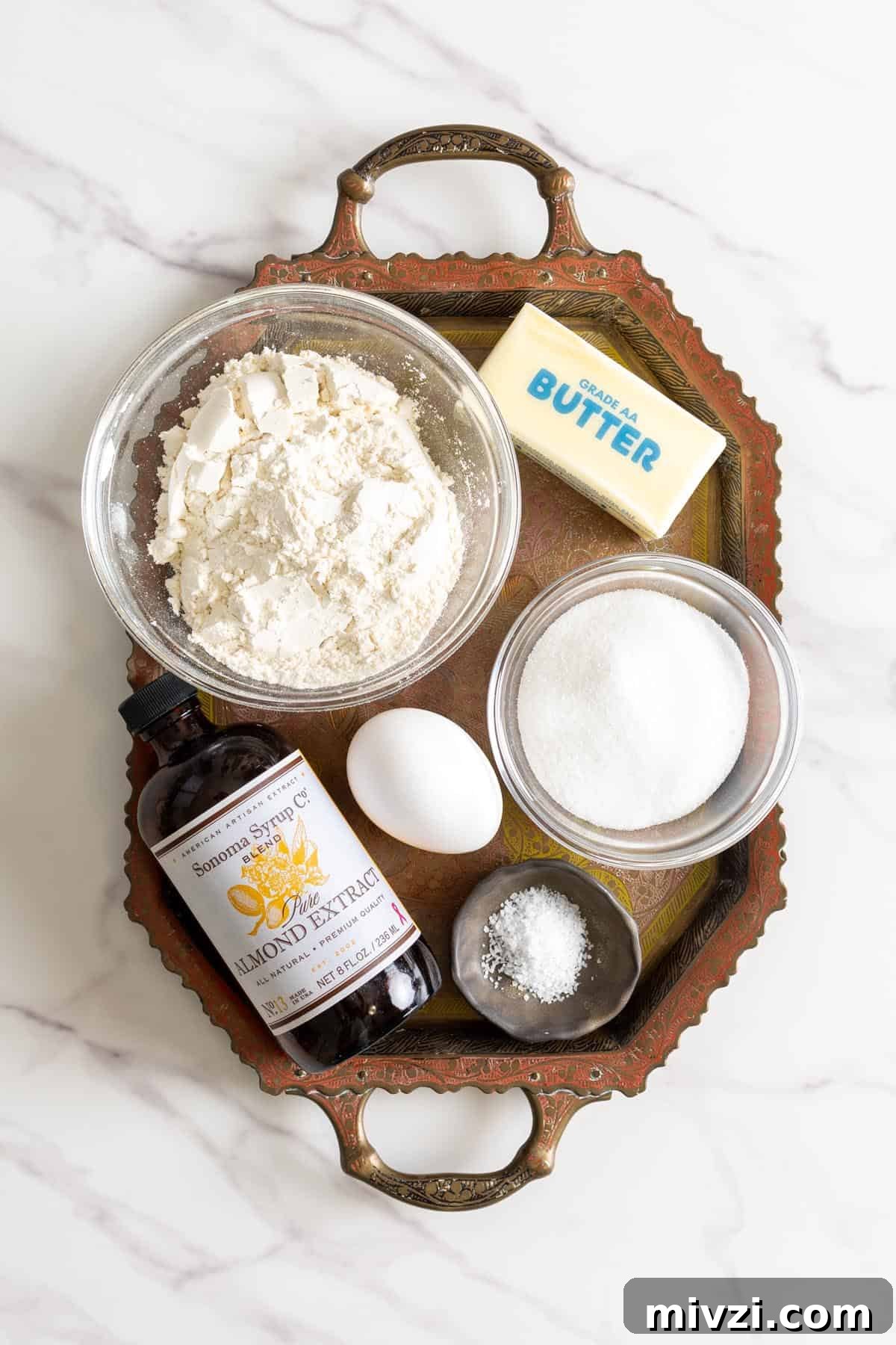 Crisp Almond Spritz Cookies Recipe for Holiday Baking 3 Almond spritz cookie ingredients on a tray.