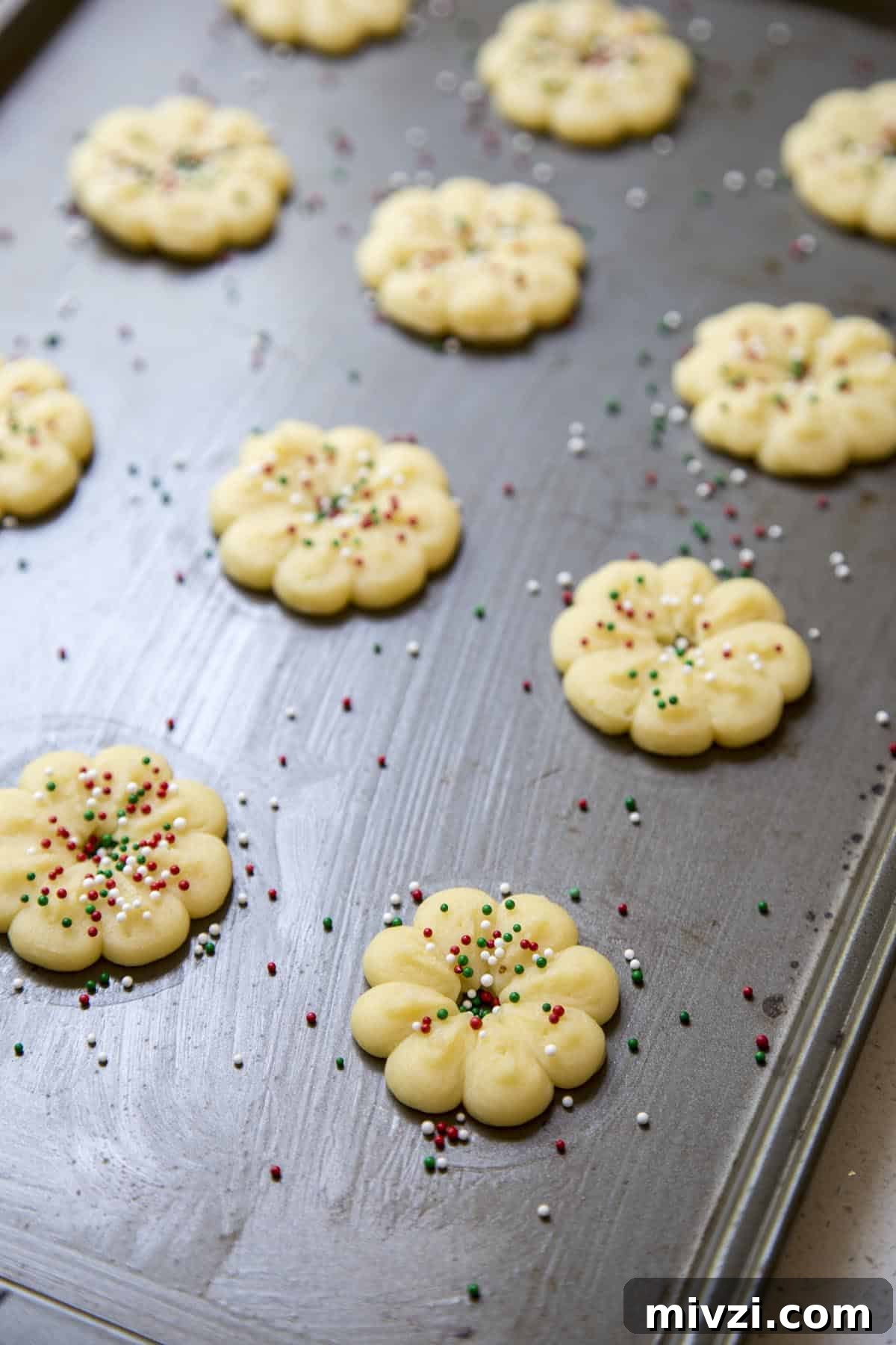 Crisp Almond Spritz Cookies Recipe for Holiday Baking 7 Add sprinkles to unbaked almond spritz cookies.