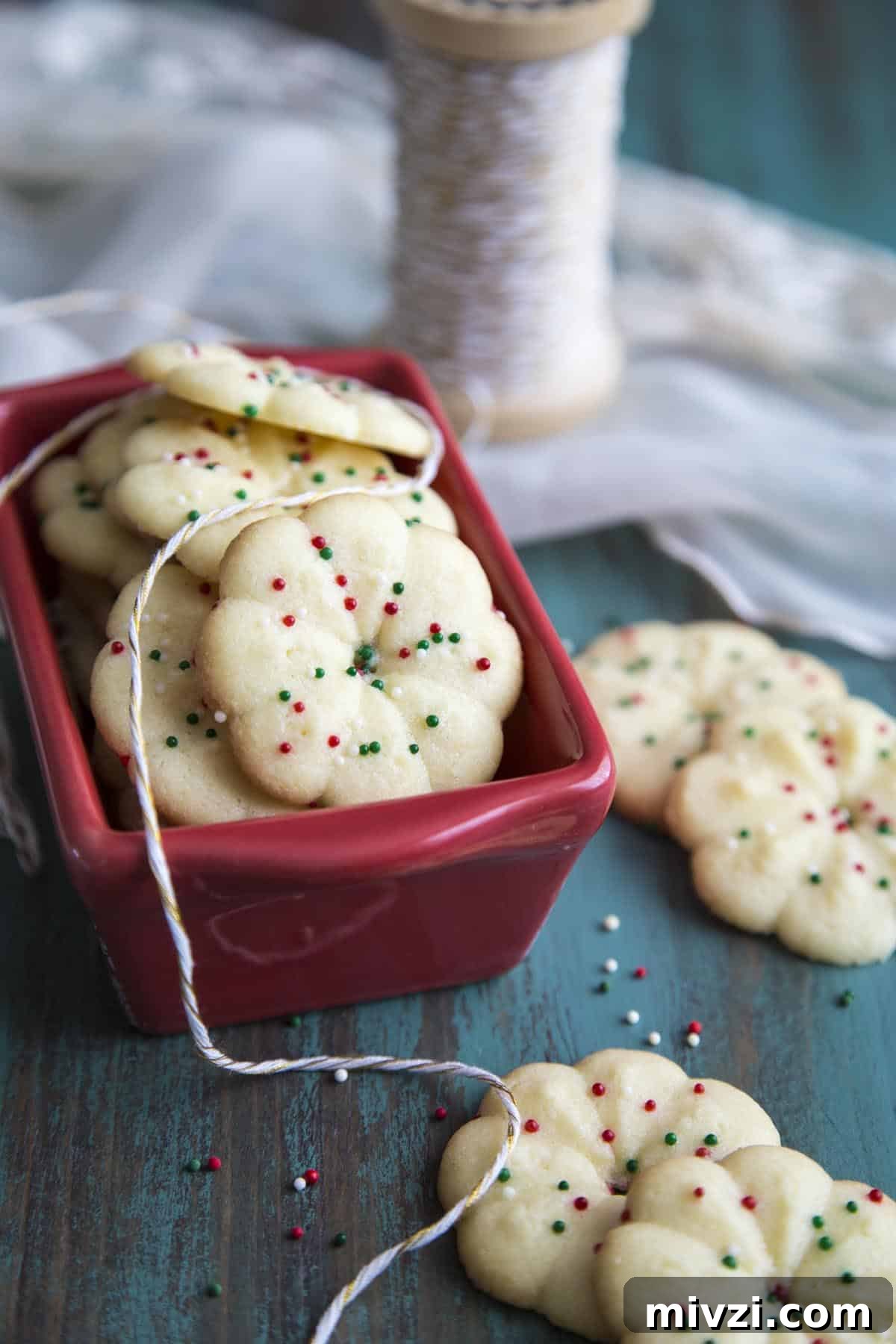 Crisp Almond Spritz Cookies Recipe for Holiday Baking 9 Almond Spritz Cookies in a red container.