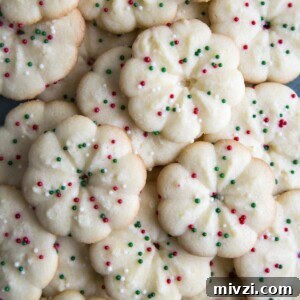 Crisp Almond Spritz Cookies Recipe for Holiday Baking 10 A pile of Almond Spritz Cookies with Christmas sprinkles.