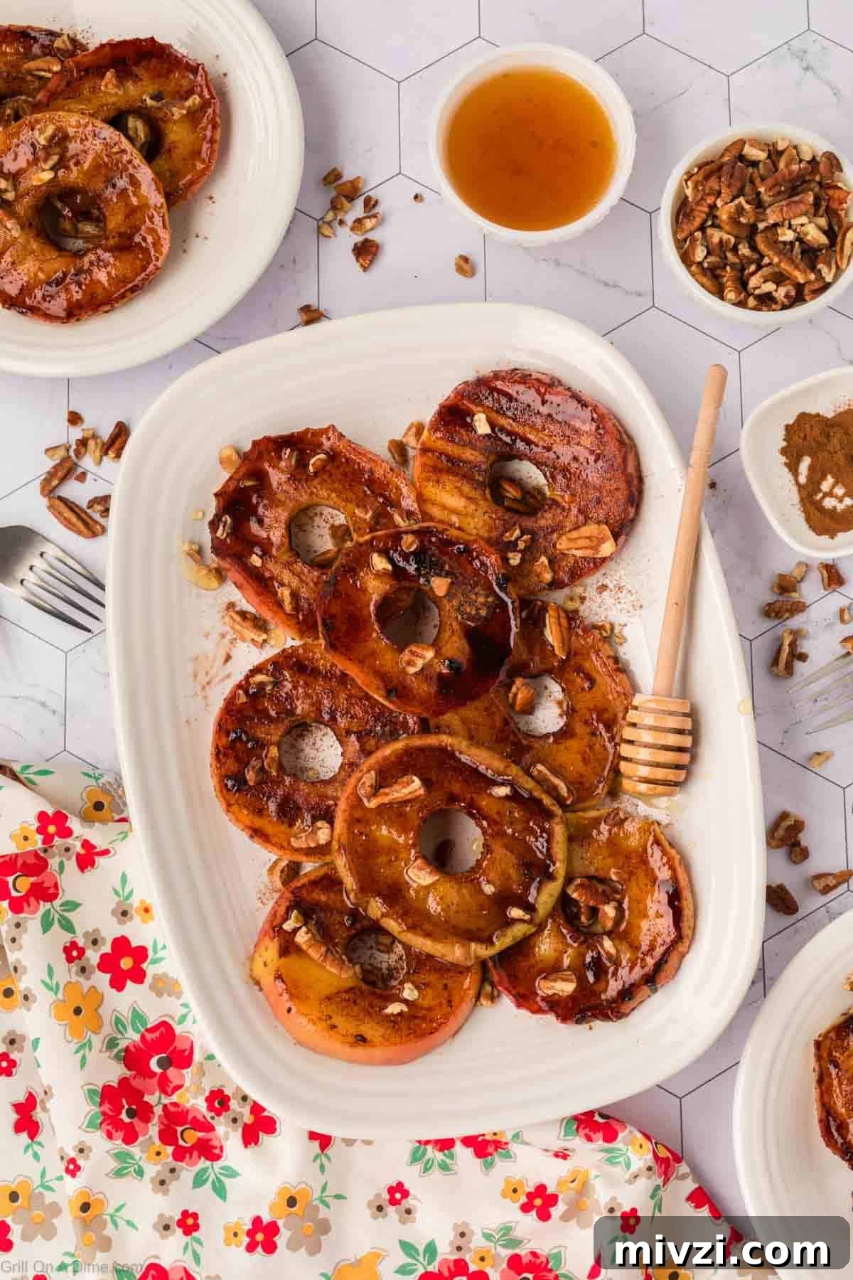 Caramelized Grilled Apples with Cinnamon and Honey 10 Apple Slices on a platter topped with the cinnamon mixture and chopped pecans