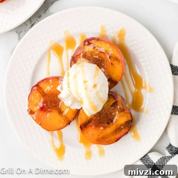 Caramelized Grilled Apples with Cinnamon and Honey 13 Grilled Peaches on a white plate topped with ice cream and a drizzle of caramel sauce