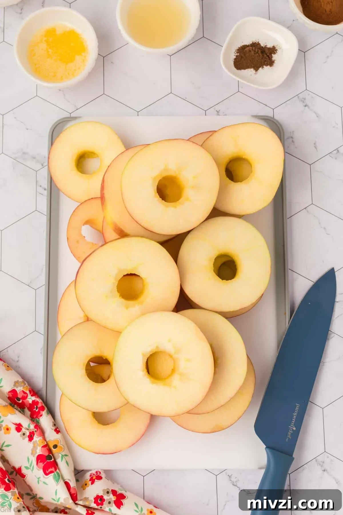 Caramelized Grilled Apples with Cinnamon and Honey 4 Apple slices on a cutting board with small bowls of spices and oil on the side