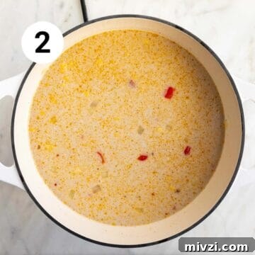 Vegan potato and corn chowder ingredients in a large pot before cooking.