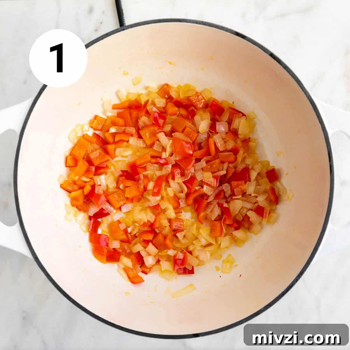 Garlic and red bell pepper sautéed in a large pot.