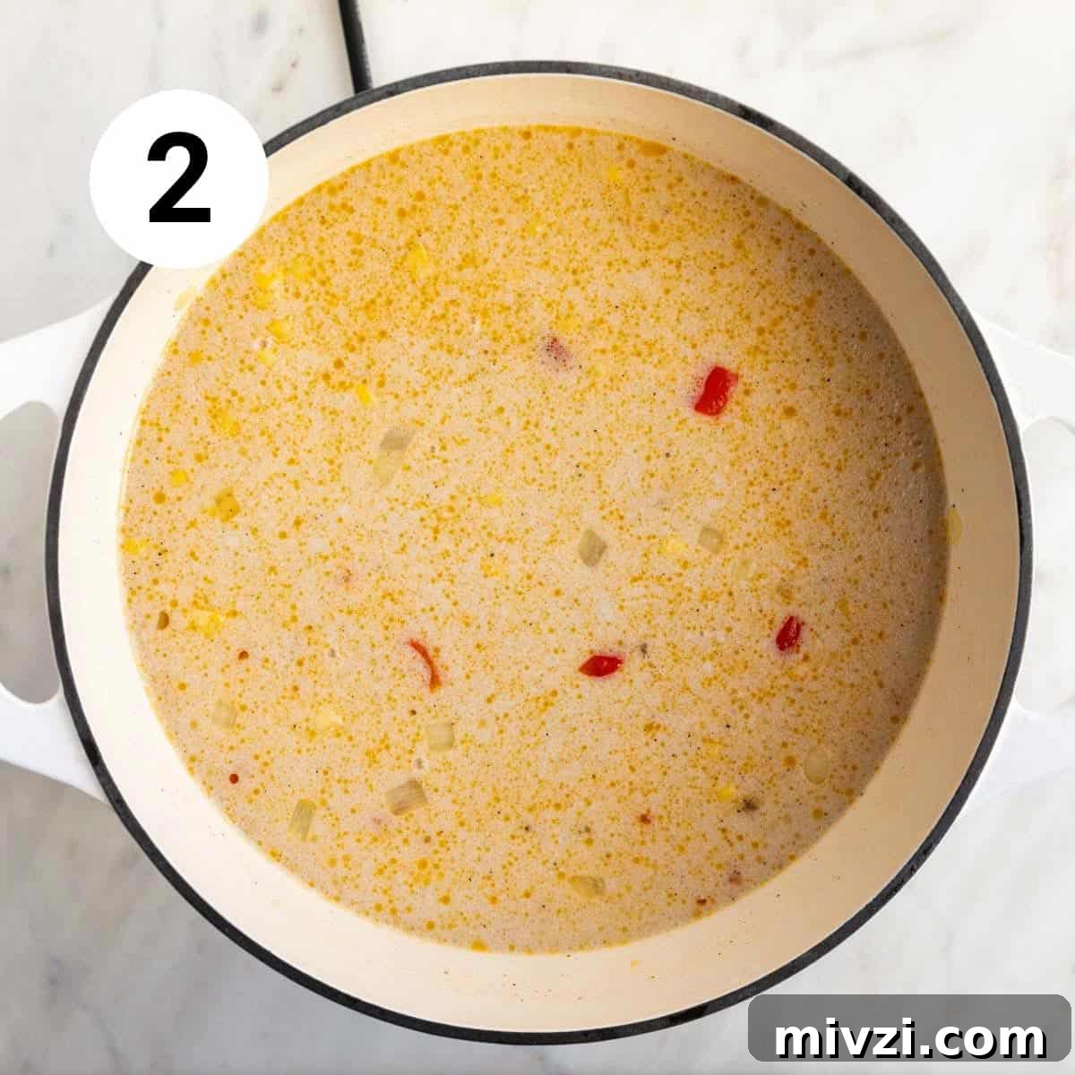 Vegan potato and corn chowder ingredients in a large pot before cooking.