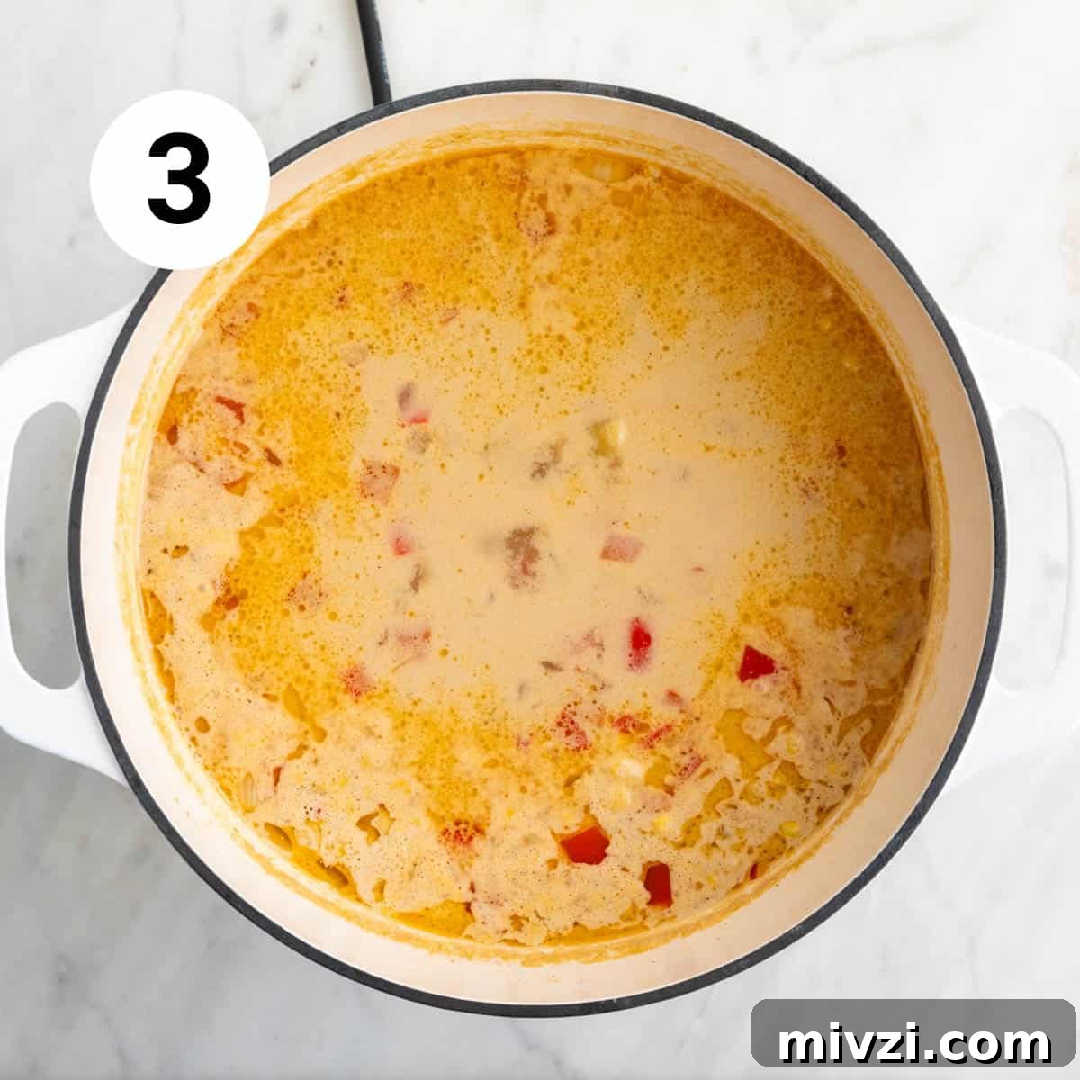 Cooked vegan potato and corn chowder in a large pot, ready for blending.