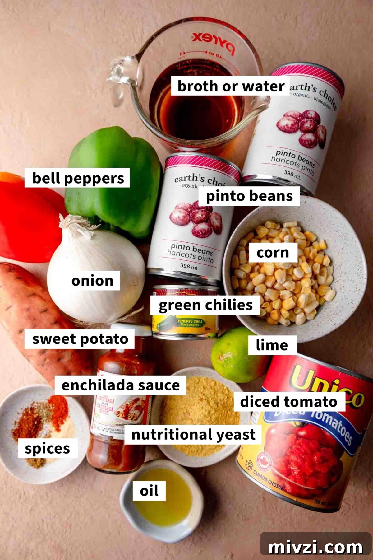 Hearty Vegan Enchilada Soup with Black Beans and Corn 3 All the ingredients gathered for making a vegan enchilada soup with pinto beans, diced tomato, sweet potato, bell pepper, nutritional yeast, broth and spices. Each ingredient is labelled with text.