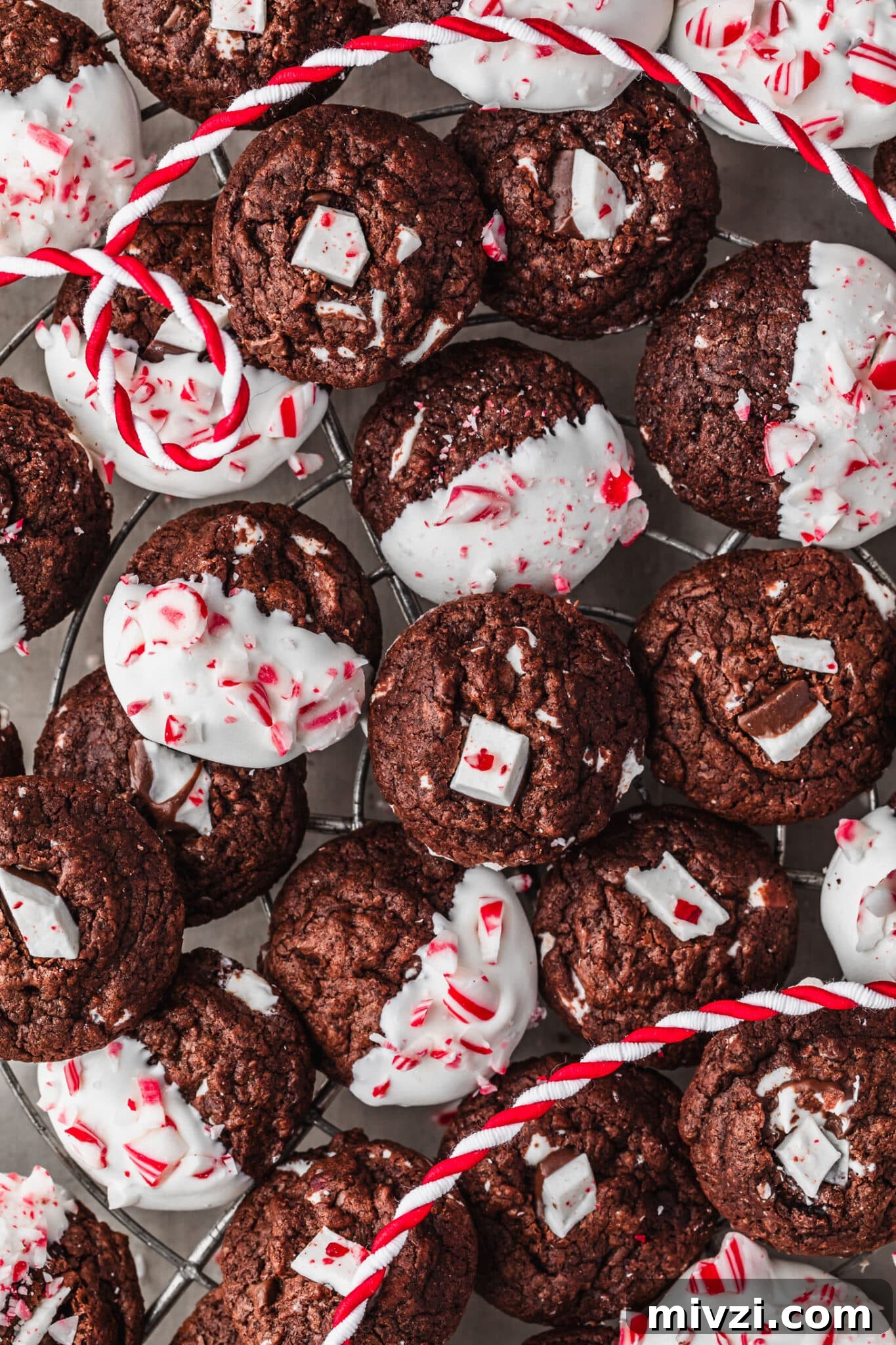 Chewy Mini Chocolate Peppermint Bark Cookies for Holiday Baking 13 A wire rack of mini chocolate peppermint bark cookies on a grey table.