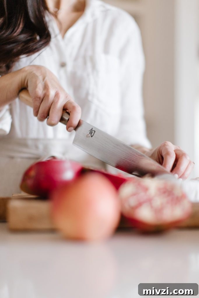 Shun Knife from crate & barrel cutting pomegranates 