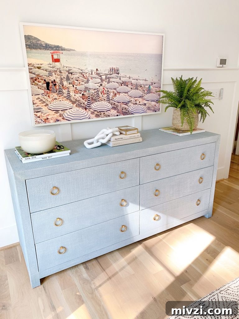 a shot of a frame TV in a bedroom over the driftway dresser