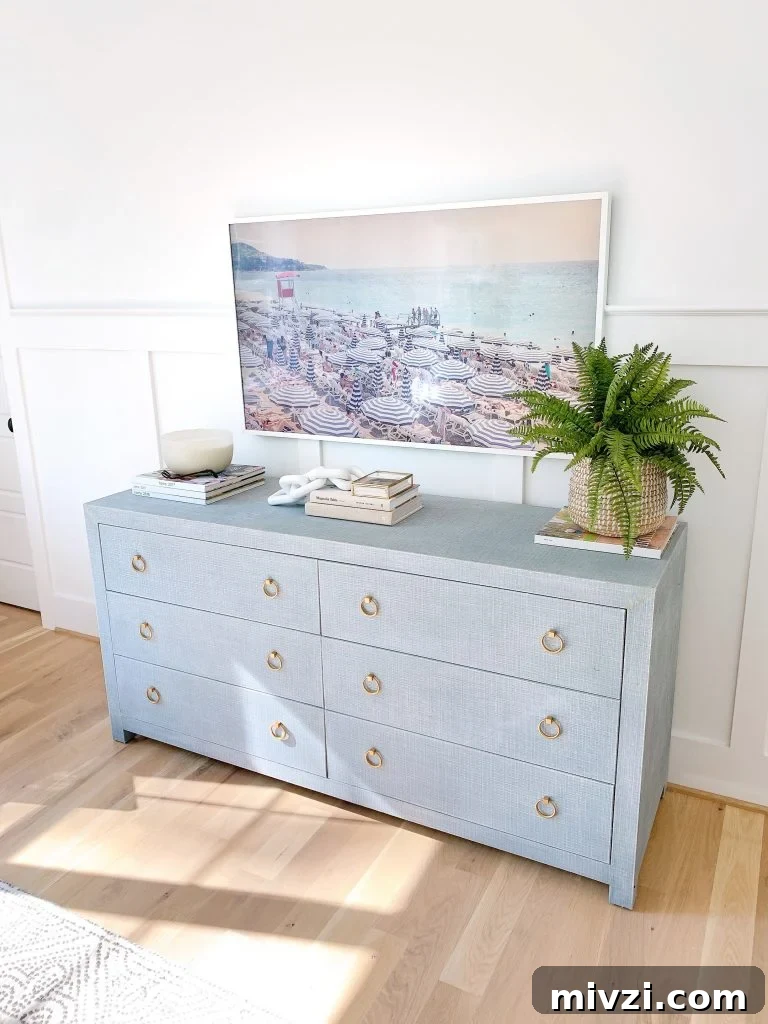 a Samsung Frame tv above a dresser
