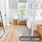 a black and white bedroom with black and white wallpaper