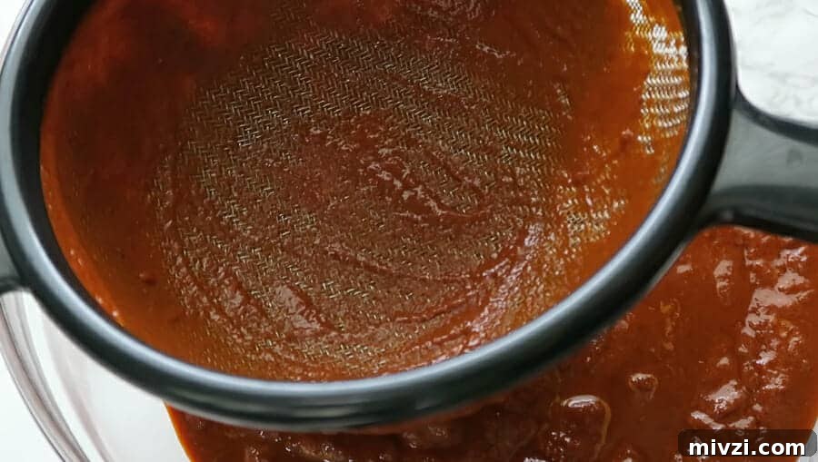 red chile sauce strained through a fine meshed sieve