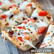 Garlic Bread Pizza with Chicken and Crispy Bacon 8 Simple Garlic Bread Pizza with mozzarella and tomatoes on a wooden board.