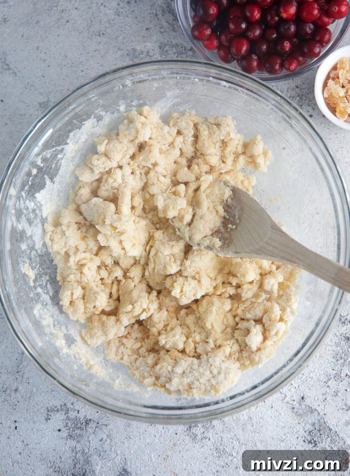 dough for cranberry orange scones in a glass mixing bowl