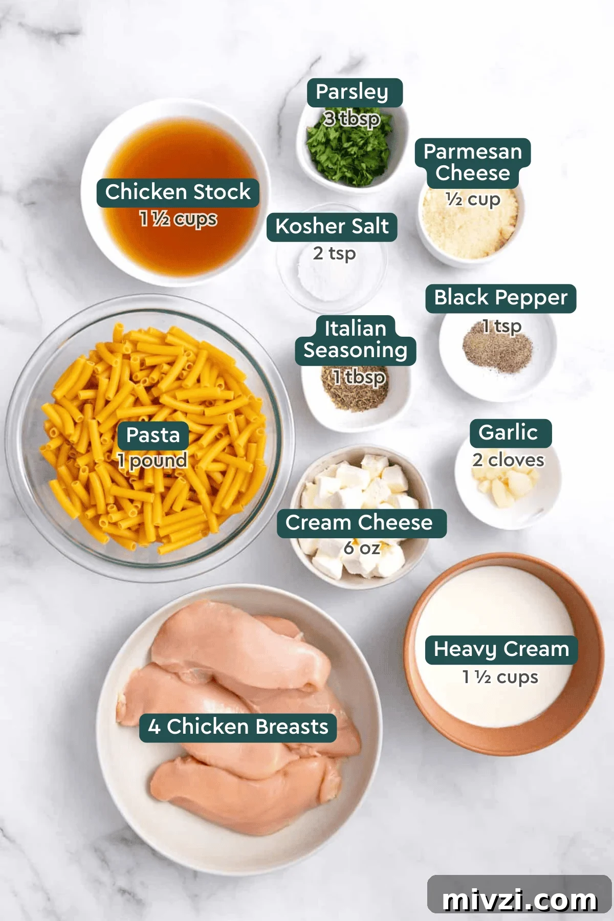 All of the ingredients for crockpot chicken alfredo in bowls on a white countertop.