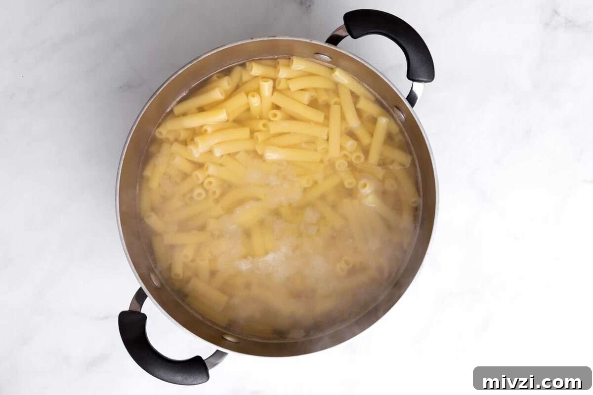 Pasta cooking in pot of water.