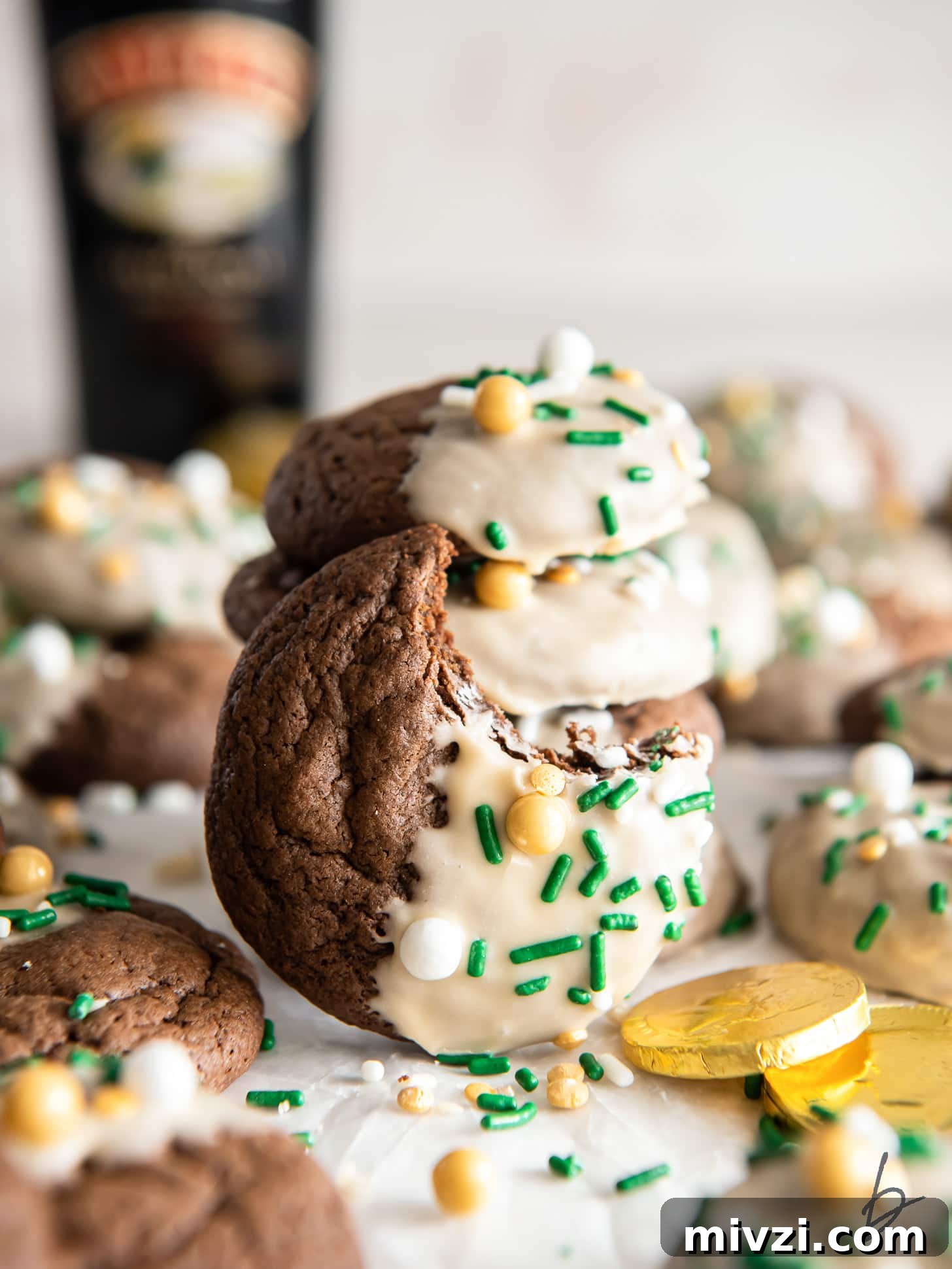 chewy bailey's irish cream cookie with a bite leaning against stack of cookies.