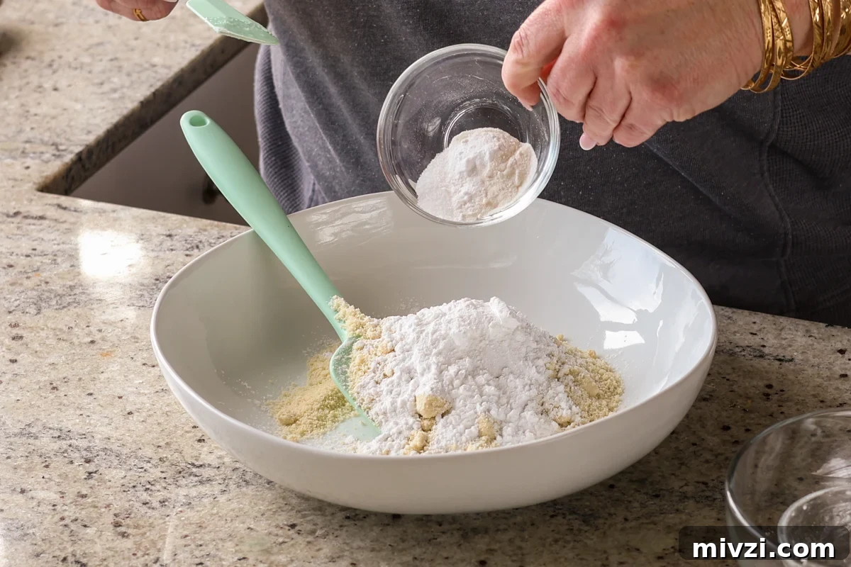 adding dry ingredients to the bowl