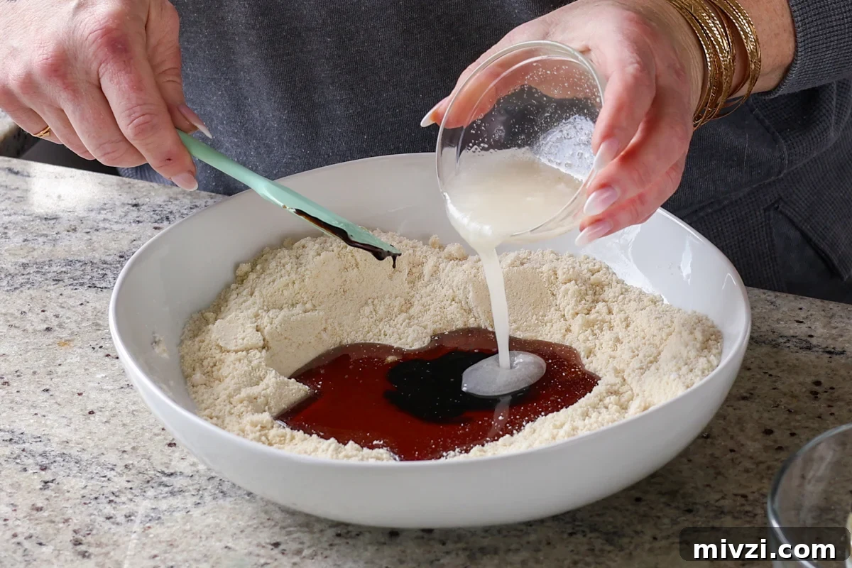 adding wet ingredients to the dry
