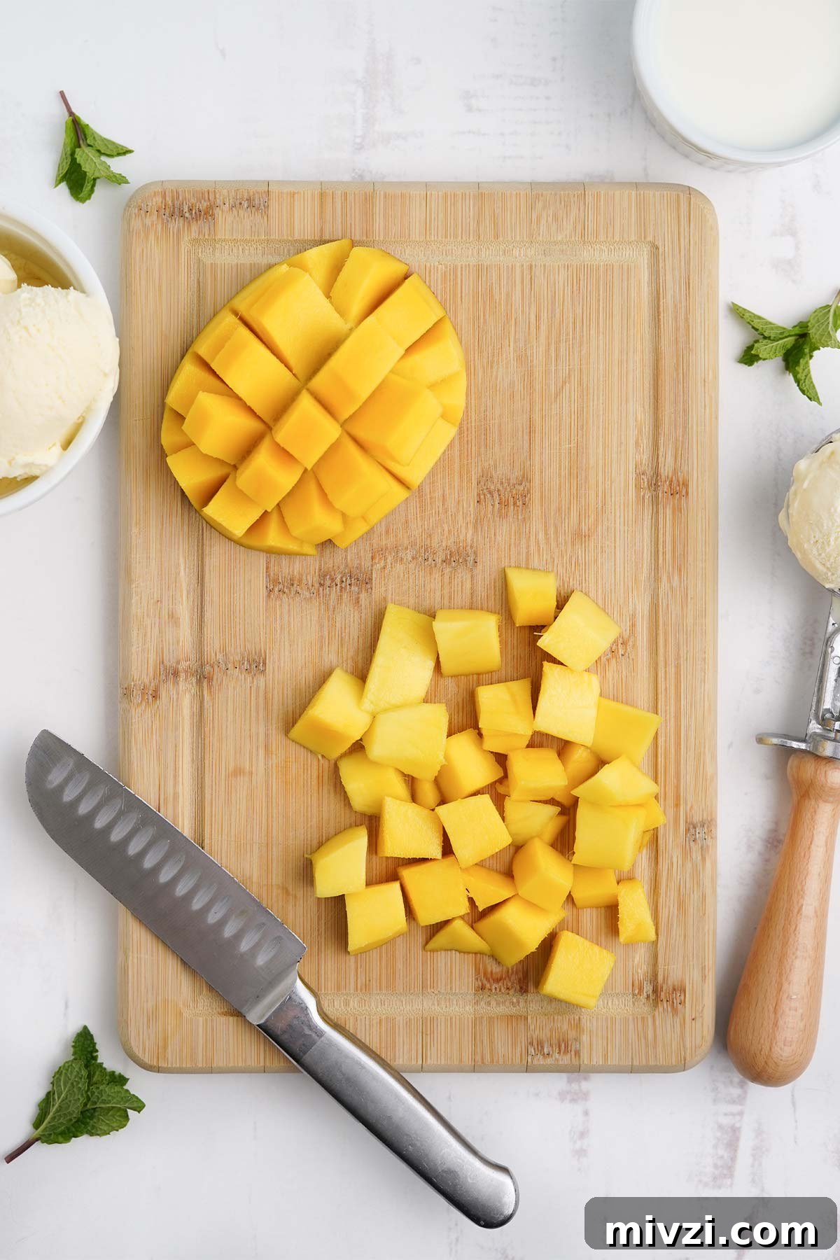 Cut mango on a cutting board.
