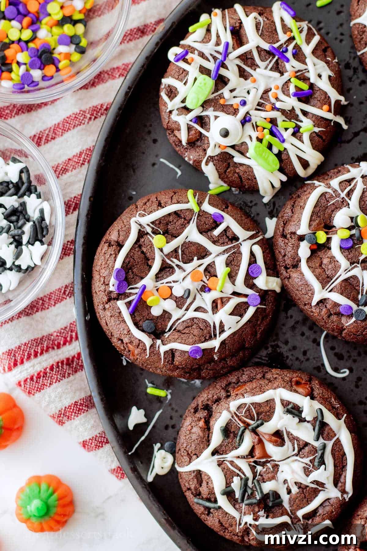 Spider Web Halloween Cookies: Step-by-Step Recipe & Decorating Tips 6 Baked spider web cookies with halloween sprinkles on black plate.