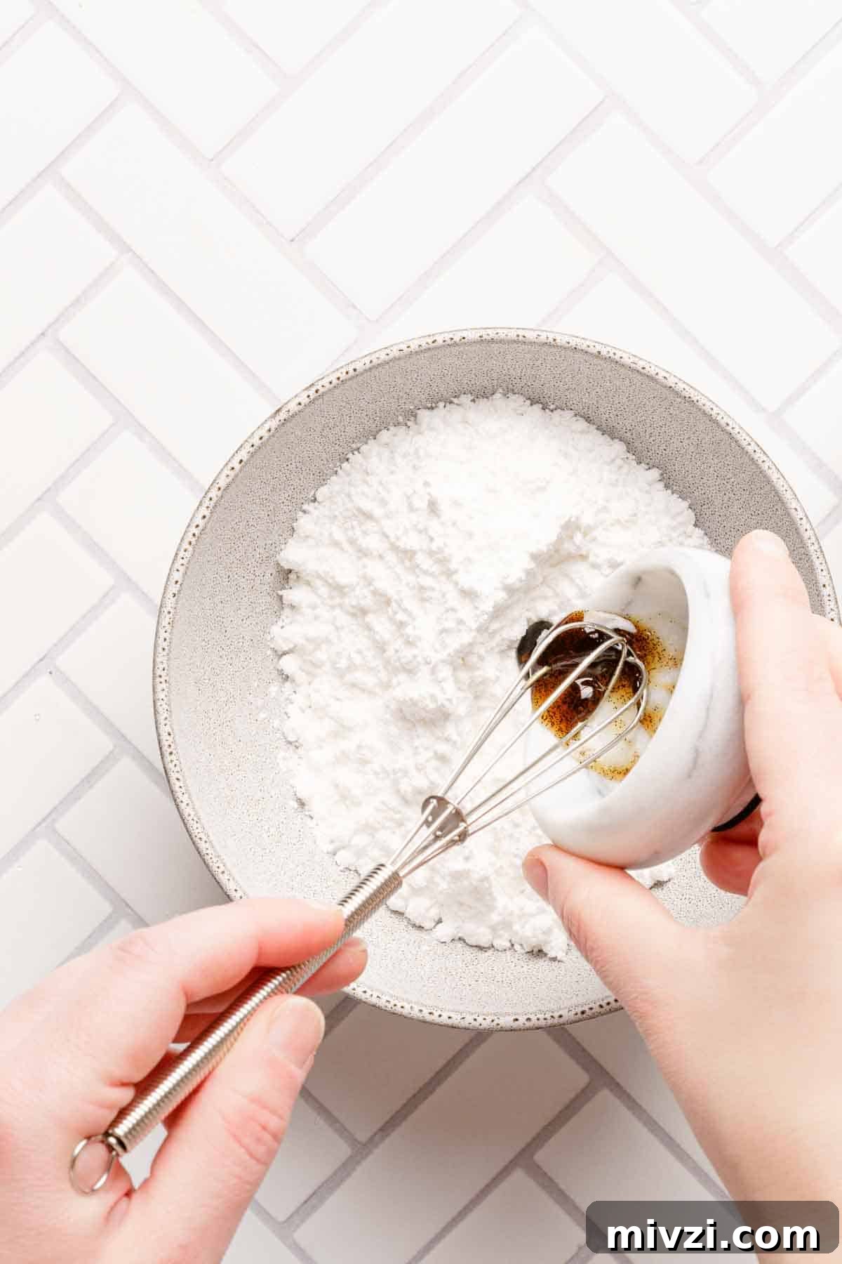 Classic Vanilla Muffins Recipe: Light, Fluffy & Quick 15 vanilla paste being added to bowl of powdered sugar.