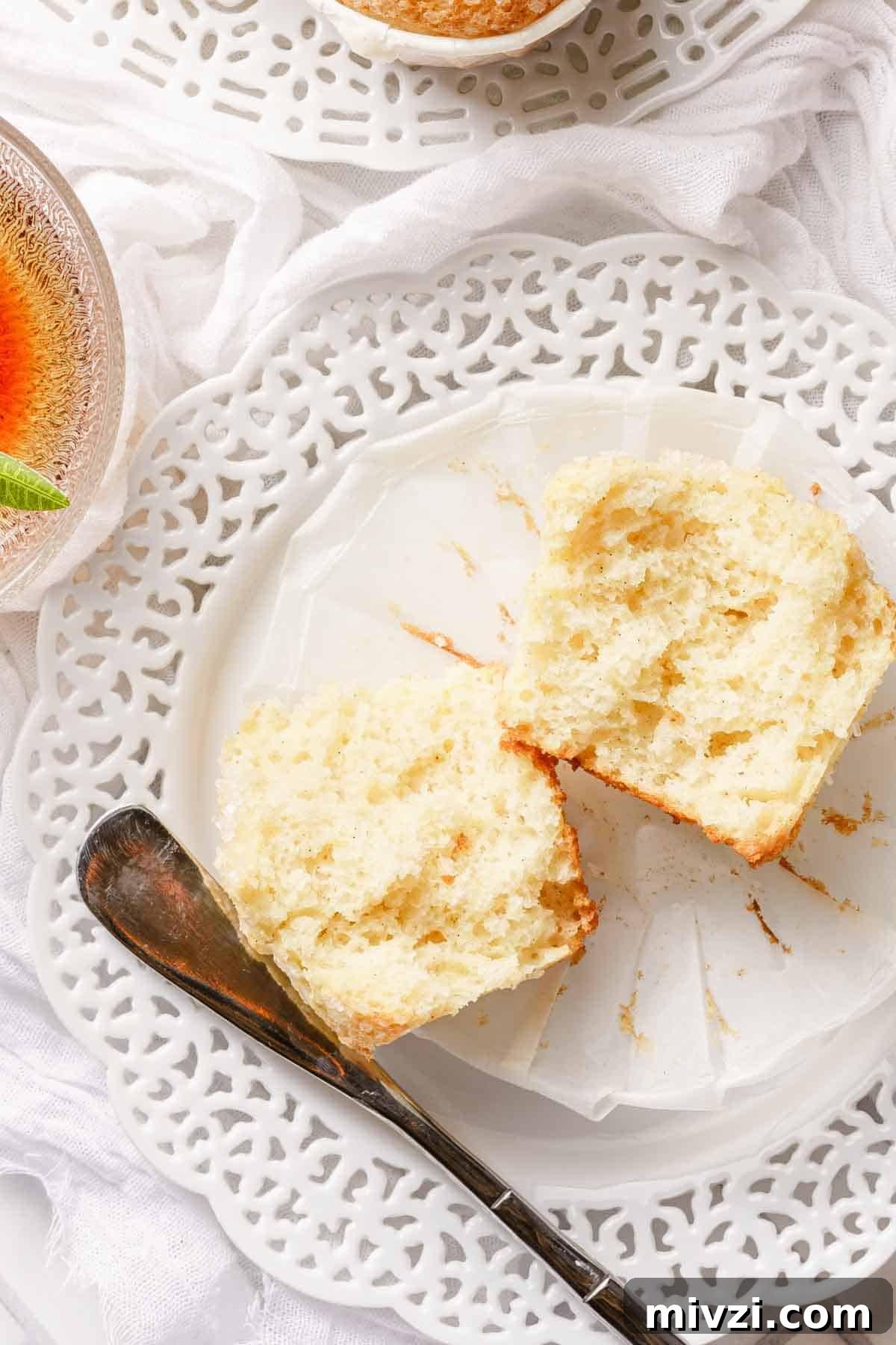 Classic Vanilla Muffins Recipe: Light, Fluffy & Quick 18 split muffin on white plate.